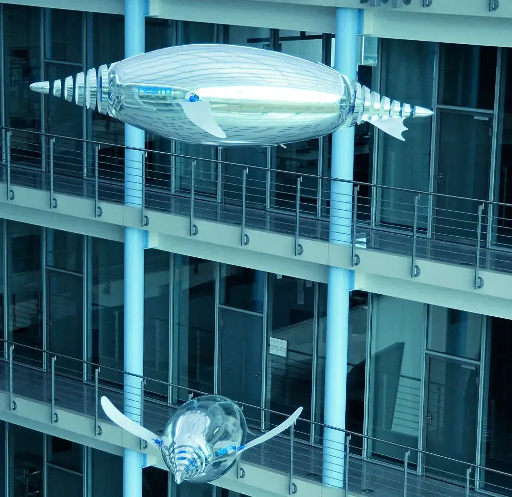 Robotic AirPenguins swimming through the air in a glass atrium