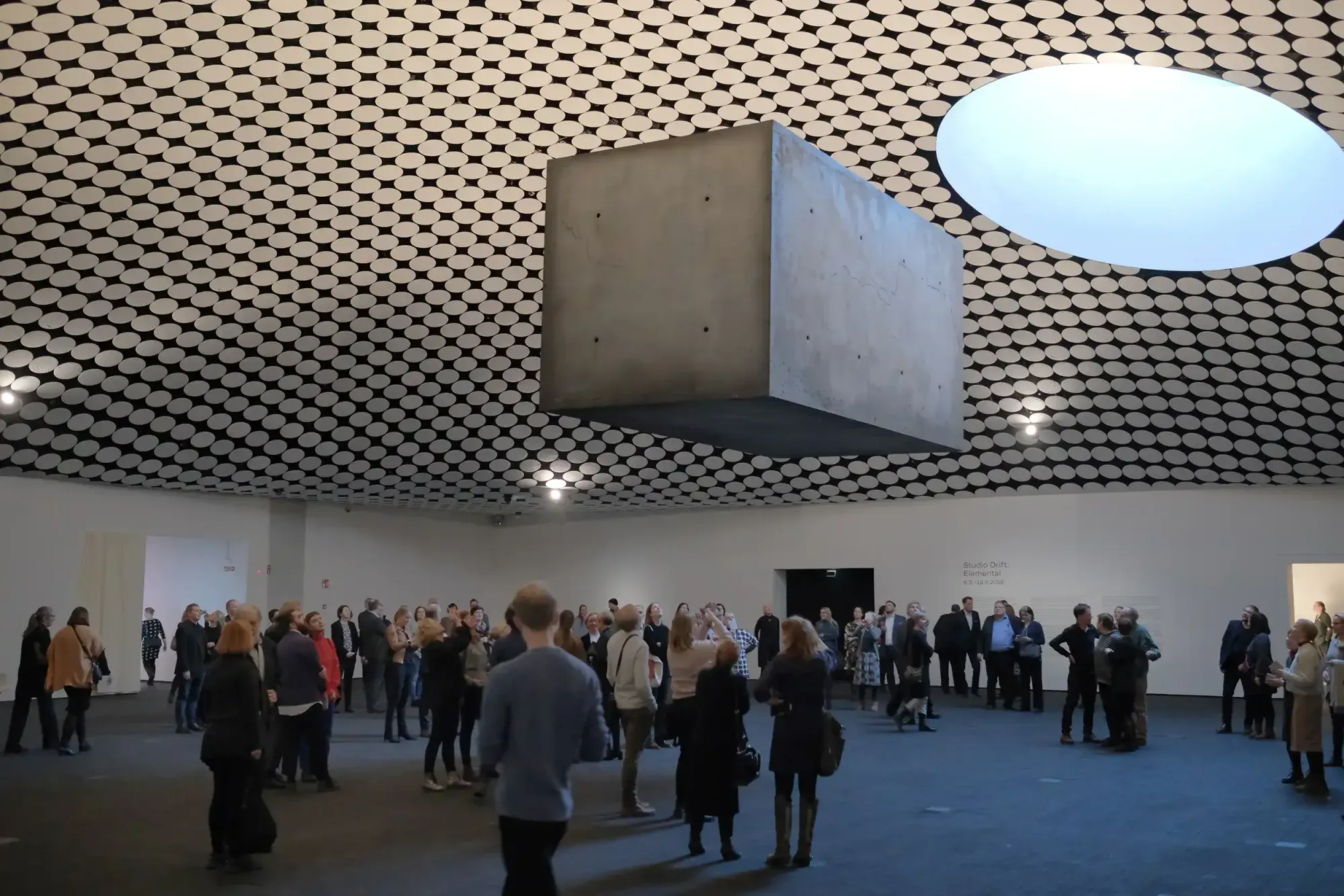 A concrete monolith floating under the domed ceiling of the Amos Rex museum in Helsinki
